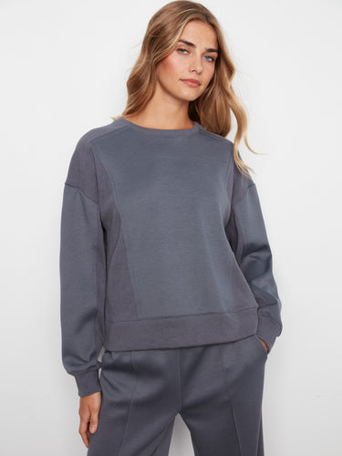 Soft scuba fabric sweatshirt with a relaxed fit, showcasing long sleeves and ribbed side panels. Designed by Charlie B.