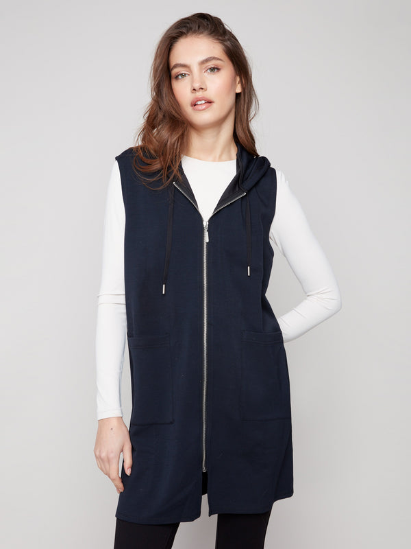 Stylish black vest with hood and drawstrings, perfect for layering over casual outfits by Charlie B.