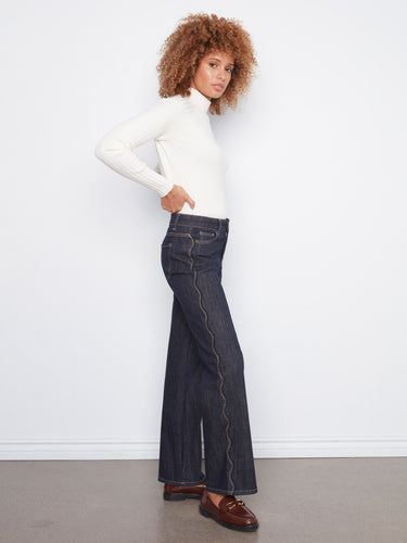 Full-length denim jeans with a scalloped outseam and raw hem, offering both style and comfort by Charlie B.