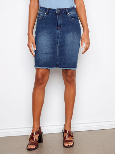 This denim skirt includes five pockets and stretches for ease of movement, styled with a light blue tank top. By Charlie B.