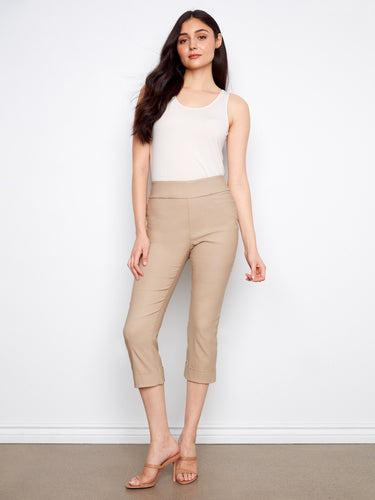 Beige capri pants with a slim leg design, featuring a stylish cuffed hem. Crafted for comfort and elegance by Charlie B.