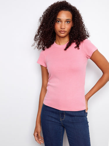 Chic pink t-shirt showcasing a ribbed texture for added style and sophistication. By Charlie B.