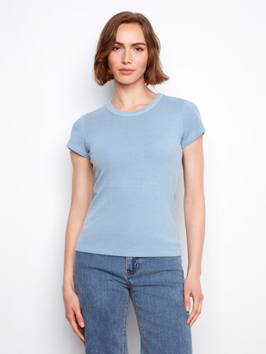 This blue top features a classic crew neck design, offering a timeless look for any wardrobe. By Charlie B.