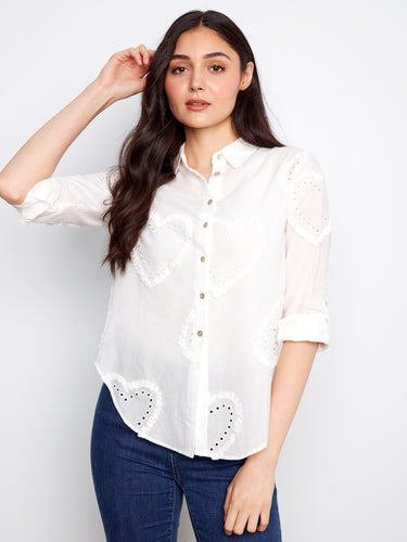 The button-down design of this shirt adds a timeless touch to any outfit, making it versatile and chic by Charlie B.