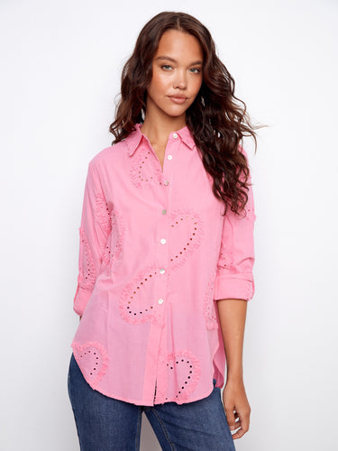 Pink blouse with button-down design, featuring textured cotton and eyelet details by Charlie B.