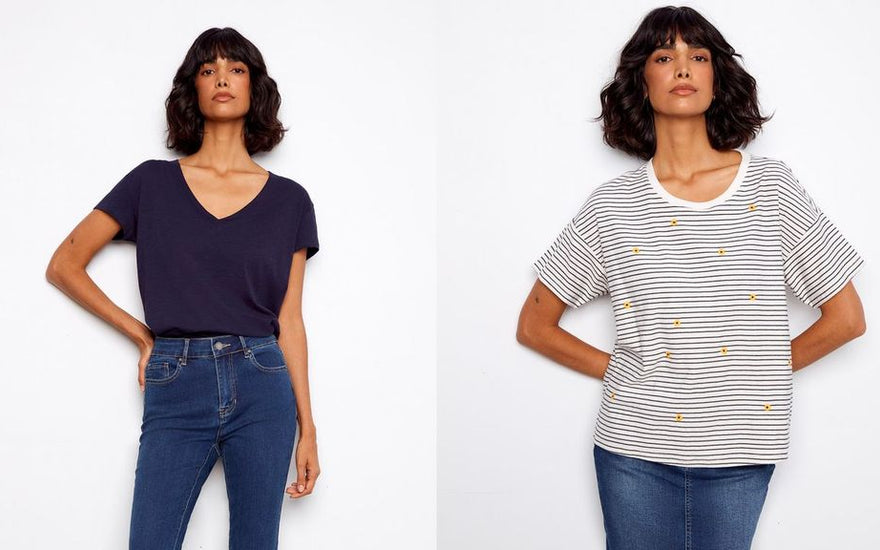 Woman wearing a navy V-neck t-shirt on the left and a white and navy striped tee with embroidered yellow flowers on the right, both paired with medium-wash blue jeans.
