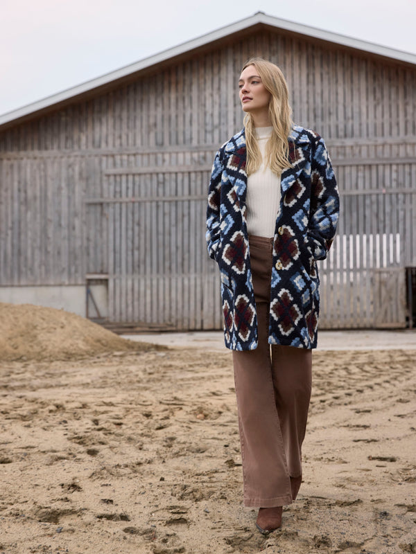 Geometric patterned crochet coat in twilight hue, offering an unlined design for easy layering by Charlie B.