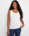 White sleeveless top featuring a scoop neckline, perfect for a casual look. The design is versatile and stylish by Charlie B.
