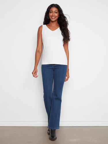 Elegant sleeveless white top that pairs seamlessly with jeans or skirts. A must-have piece by Charlie B.