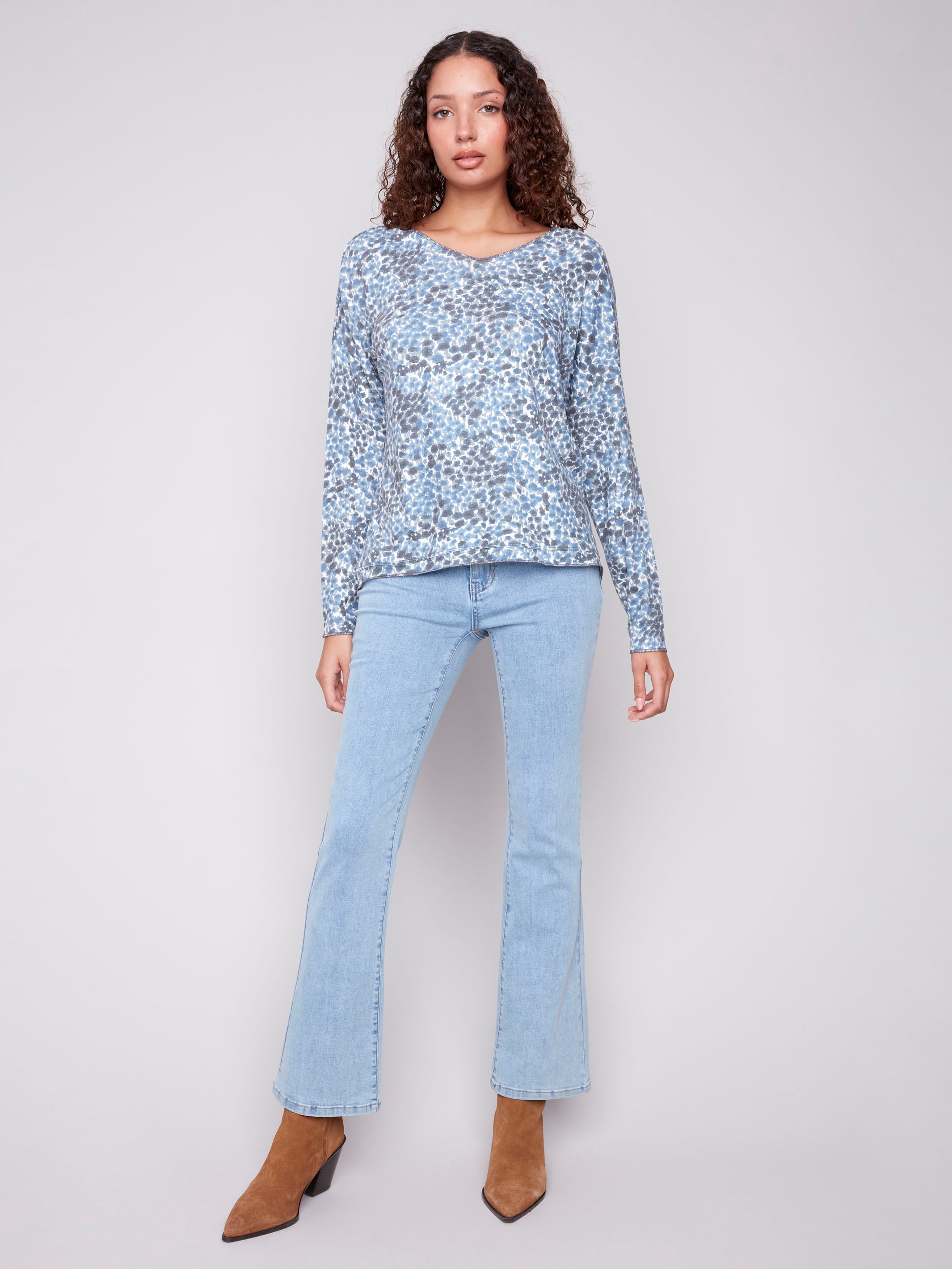Stylish blue V-neck knit top featuring drop shoulders and a unique pattern by Charlie B.