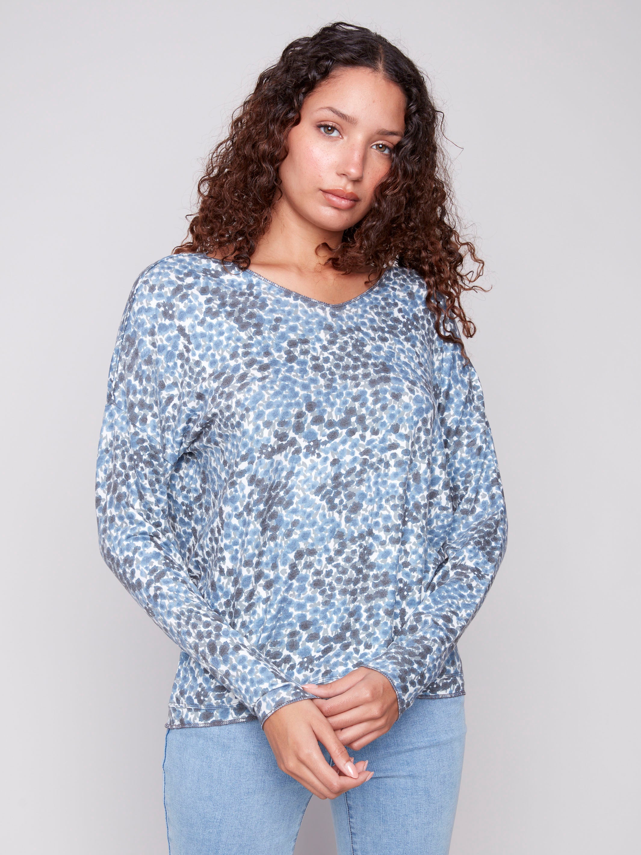 Long-sleeved blue knit top with comfortable relaxed fit and charming ditsy print by Charlie B.
