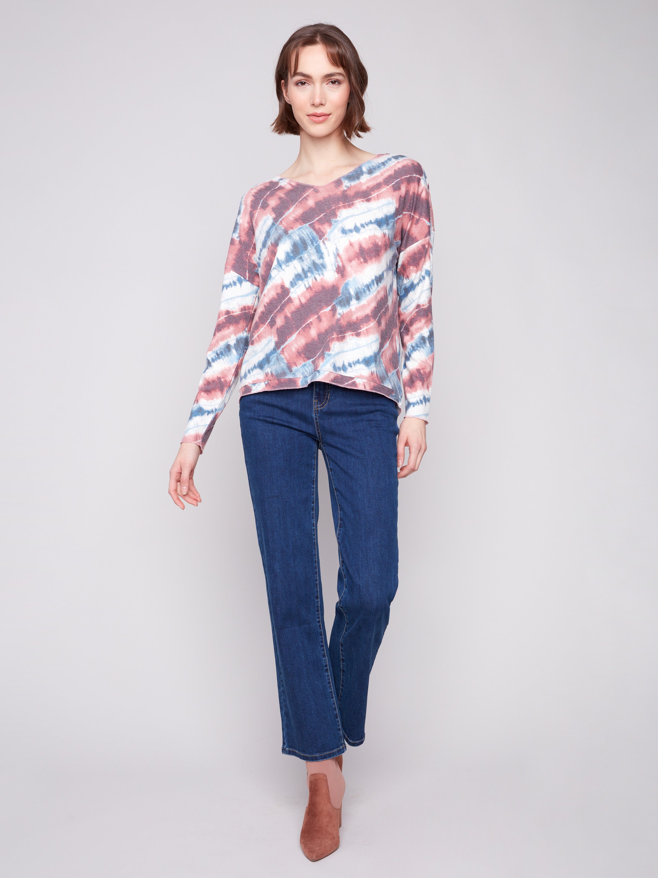 Stylish drop shoulders enhance this pink long-sleeved knit top with tie-dye print by Charlie B.