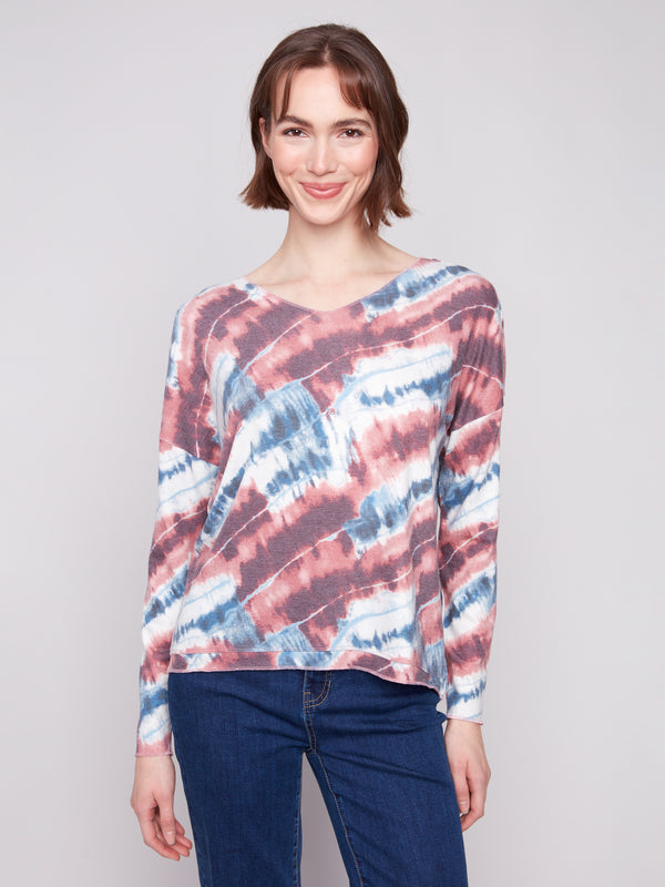 Elegant drop shoulder design on this long-sleeved pink tie-dye knit top adds flair by Charlie B.