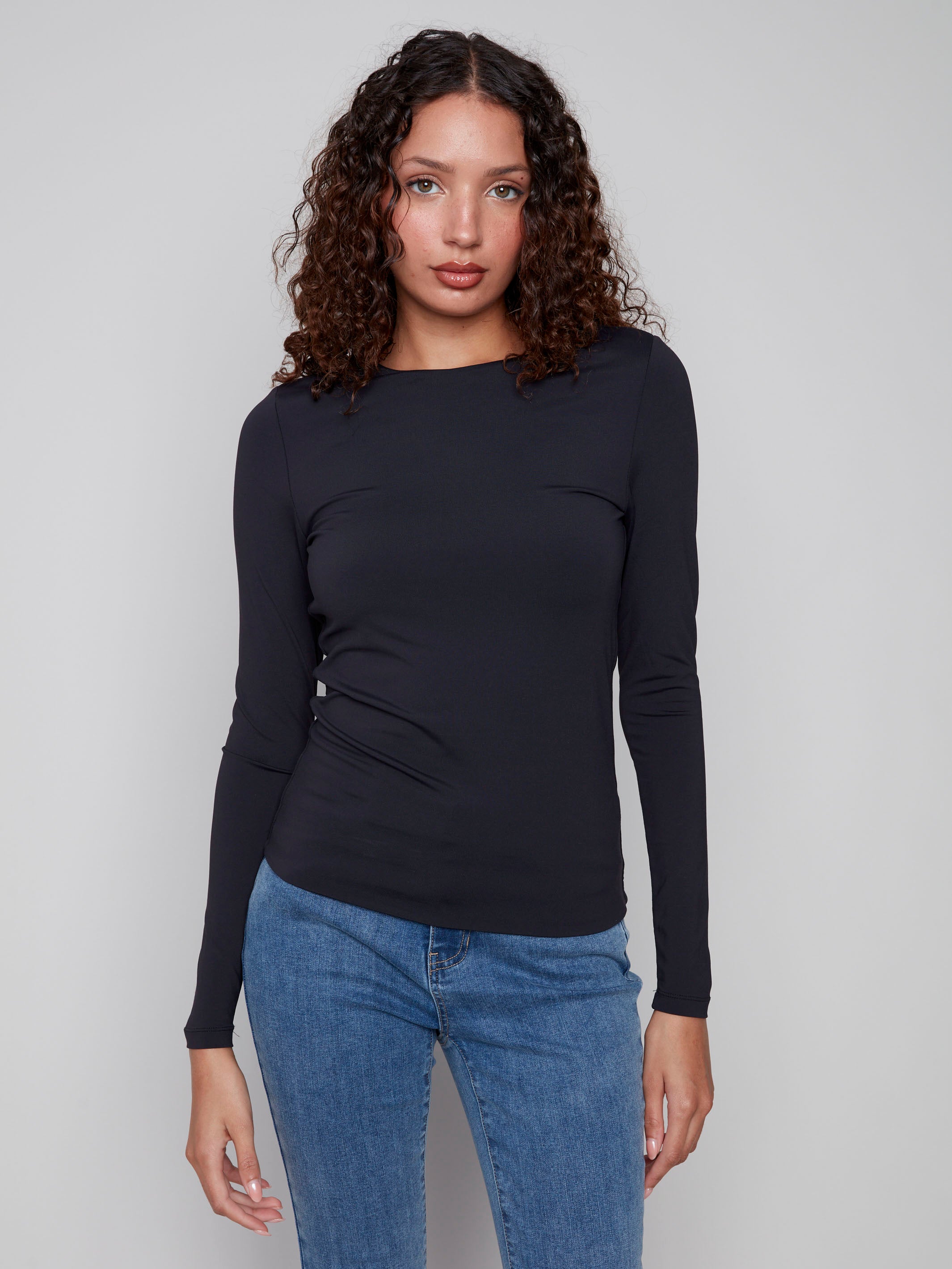 Black long-sleeve top with a crew neck, featuring a sleek fit and super stretchy fabric by Charlie B.