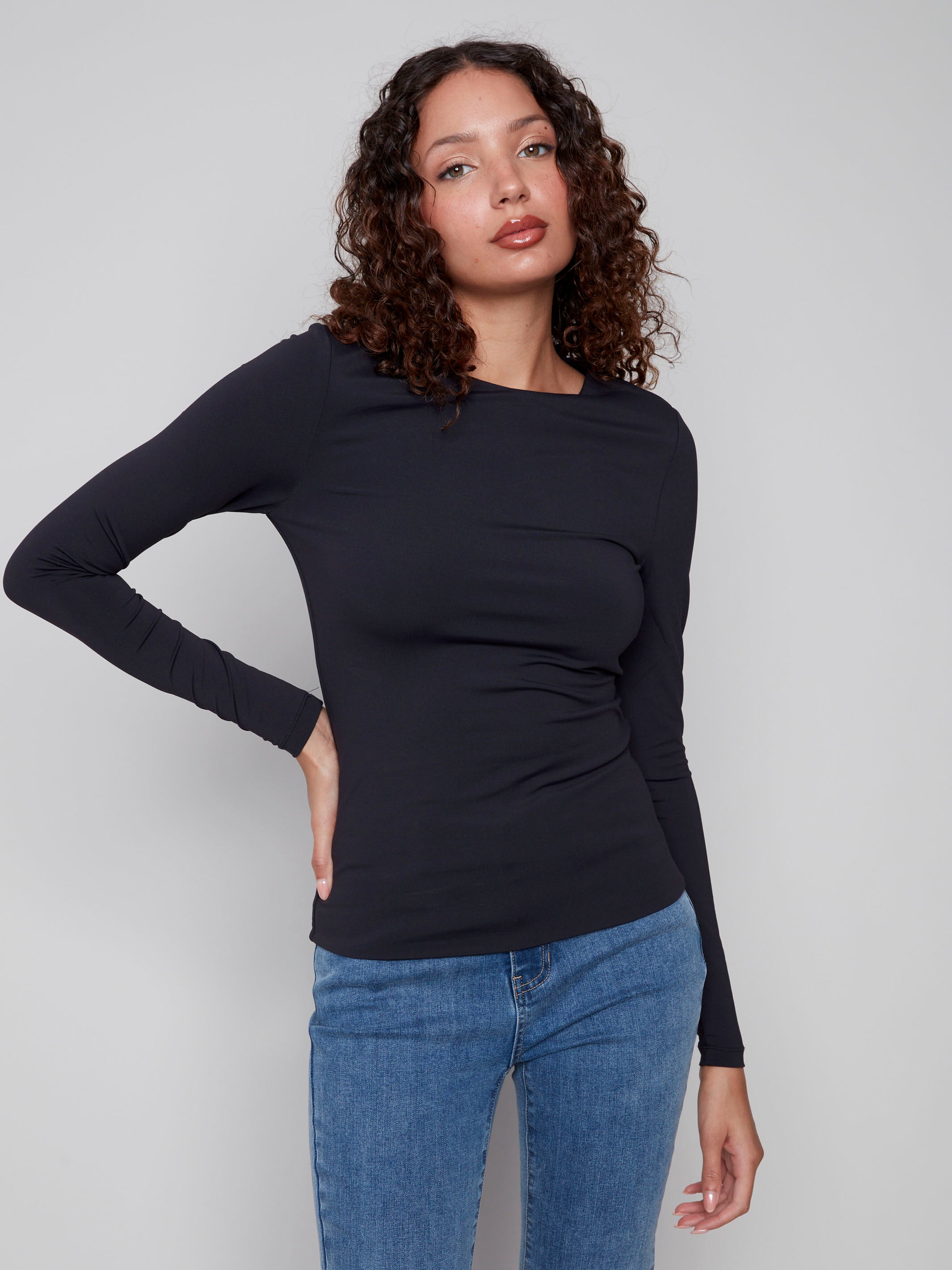 Black long-sleeve top with a crew neck, featuring a sleek fit and super stretchy fabric by Charlie B.