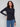 Black long-sleeve top with a crew neck, featuring a sleek fit and super stretchy fabric by Charlie B.