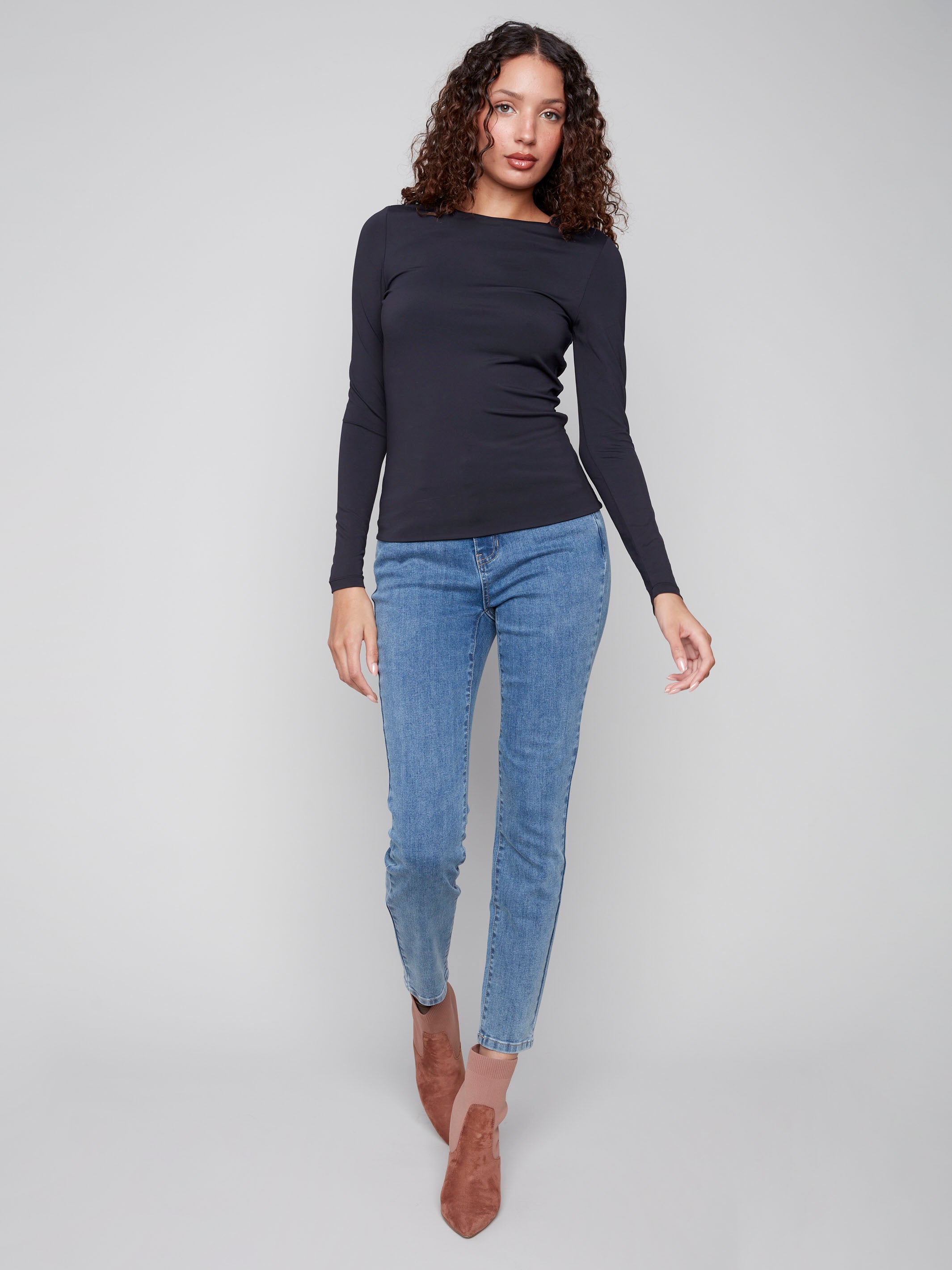 Black long-sleeve top with a crew neck, featuring a sleek fit and super stretchy fabric by Charlie B.