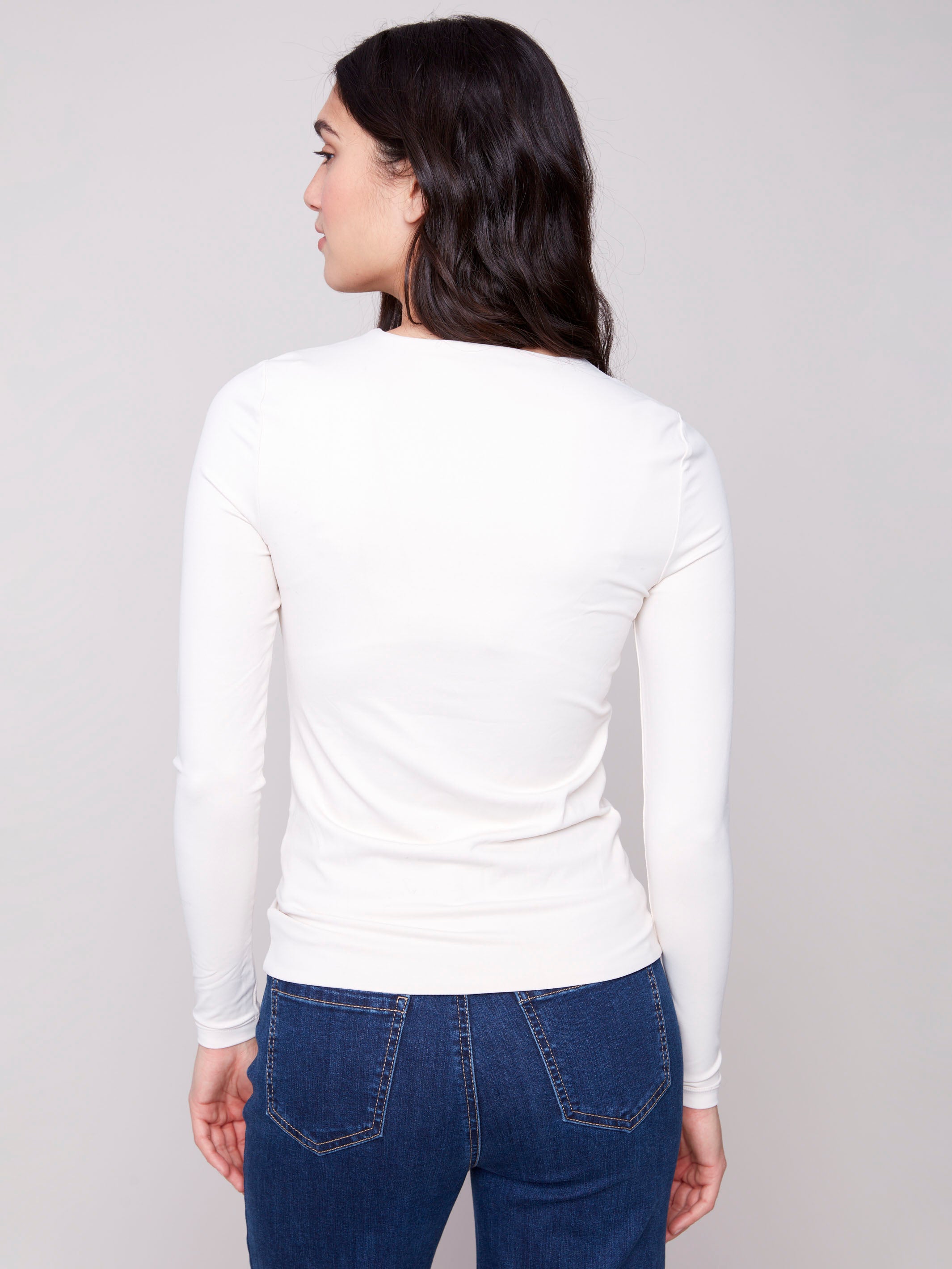 Natural long-sleeve top with a crew neck, featuring a sleek fit and super stretchy fabric by Charlie B.