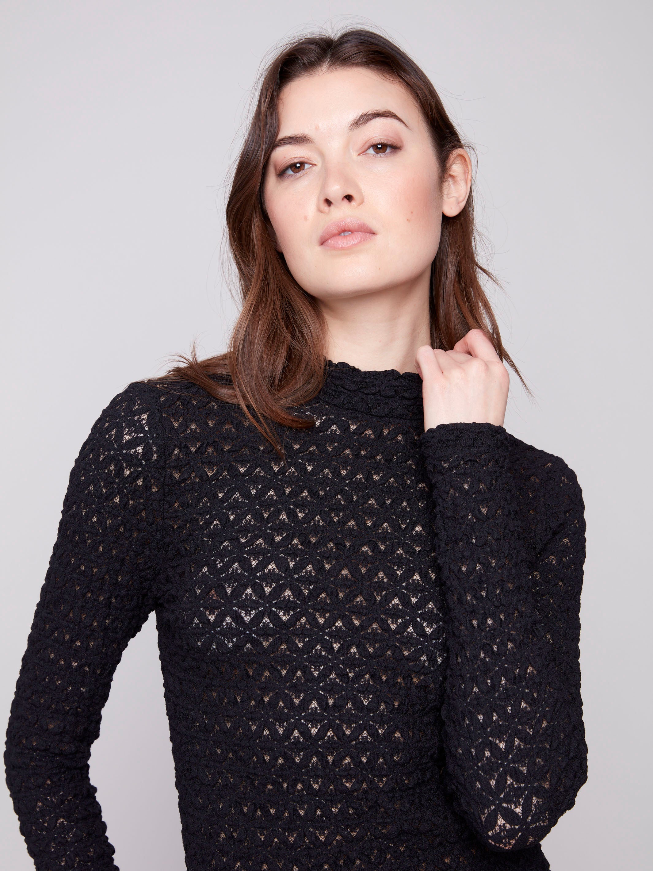 Chic black lace top showcasing a mock neck and detailed craftsmanship for added sophistication by Charlie B.