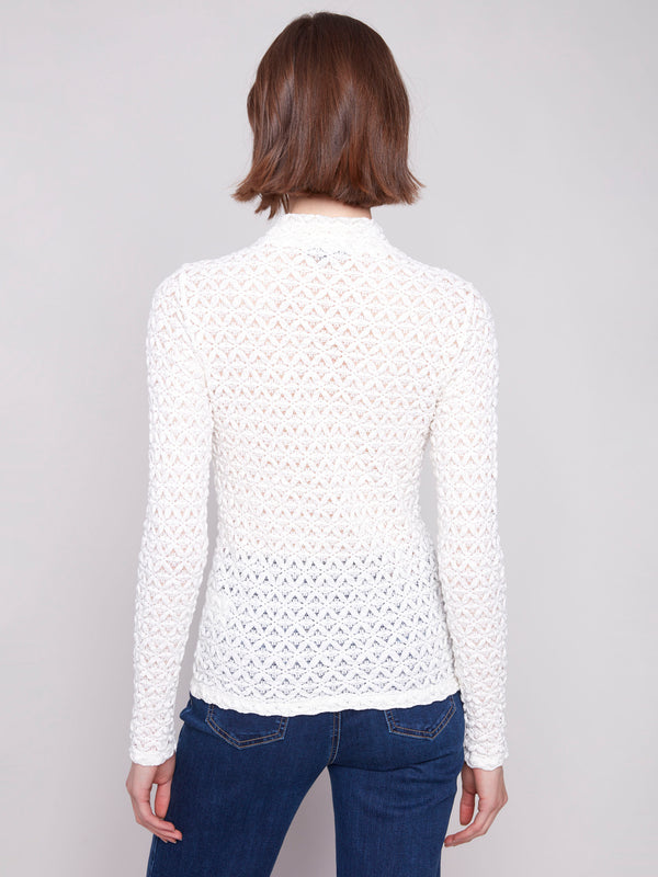 Elegant ecru top with detailed lace pattern and semi-sheer finish, enhancing any outfit by Charlie B.