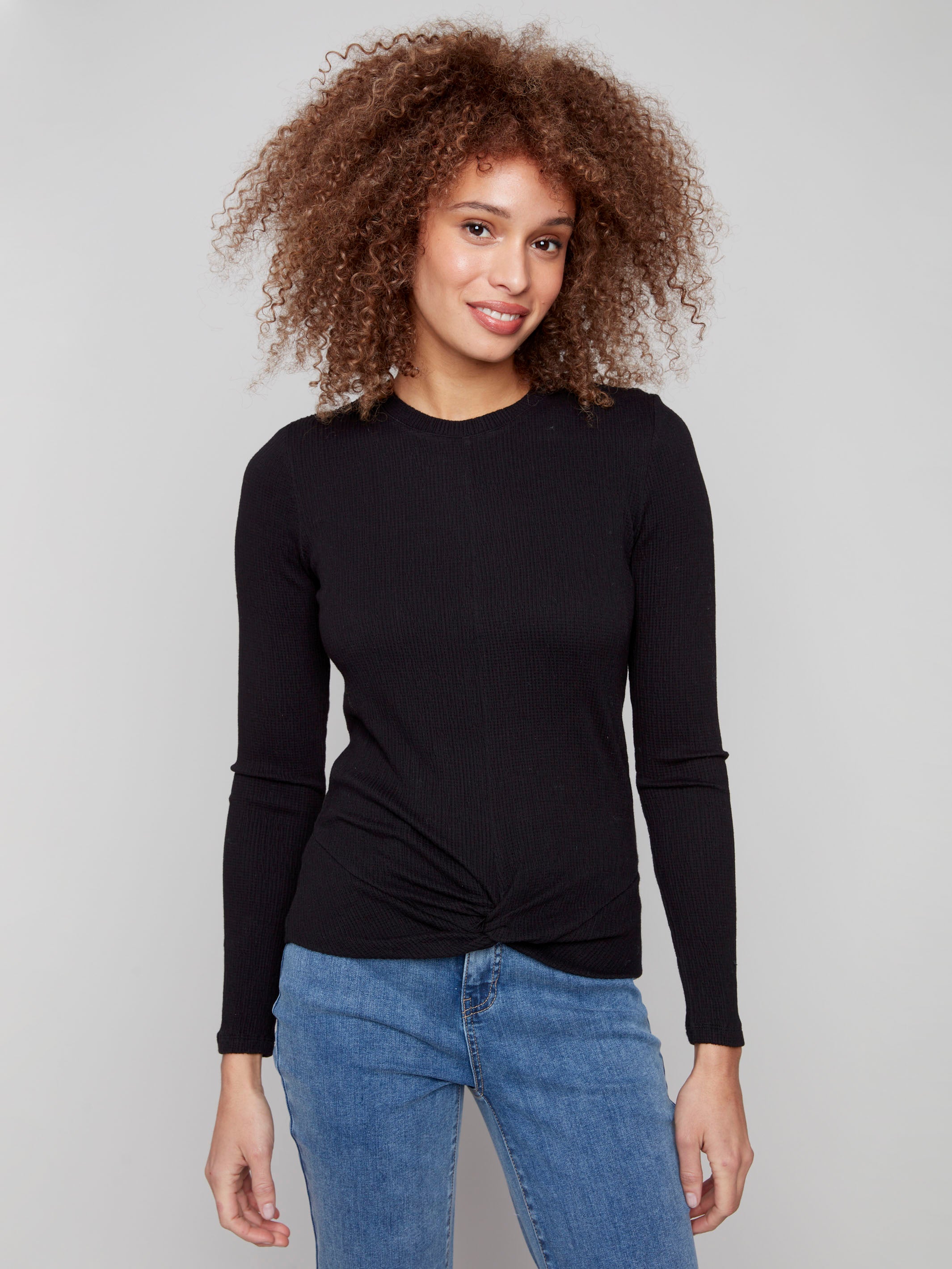 Black long sleeve textured knit top with a front knot by Charlie B.