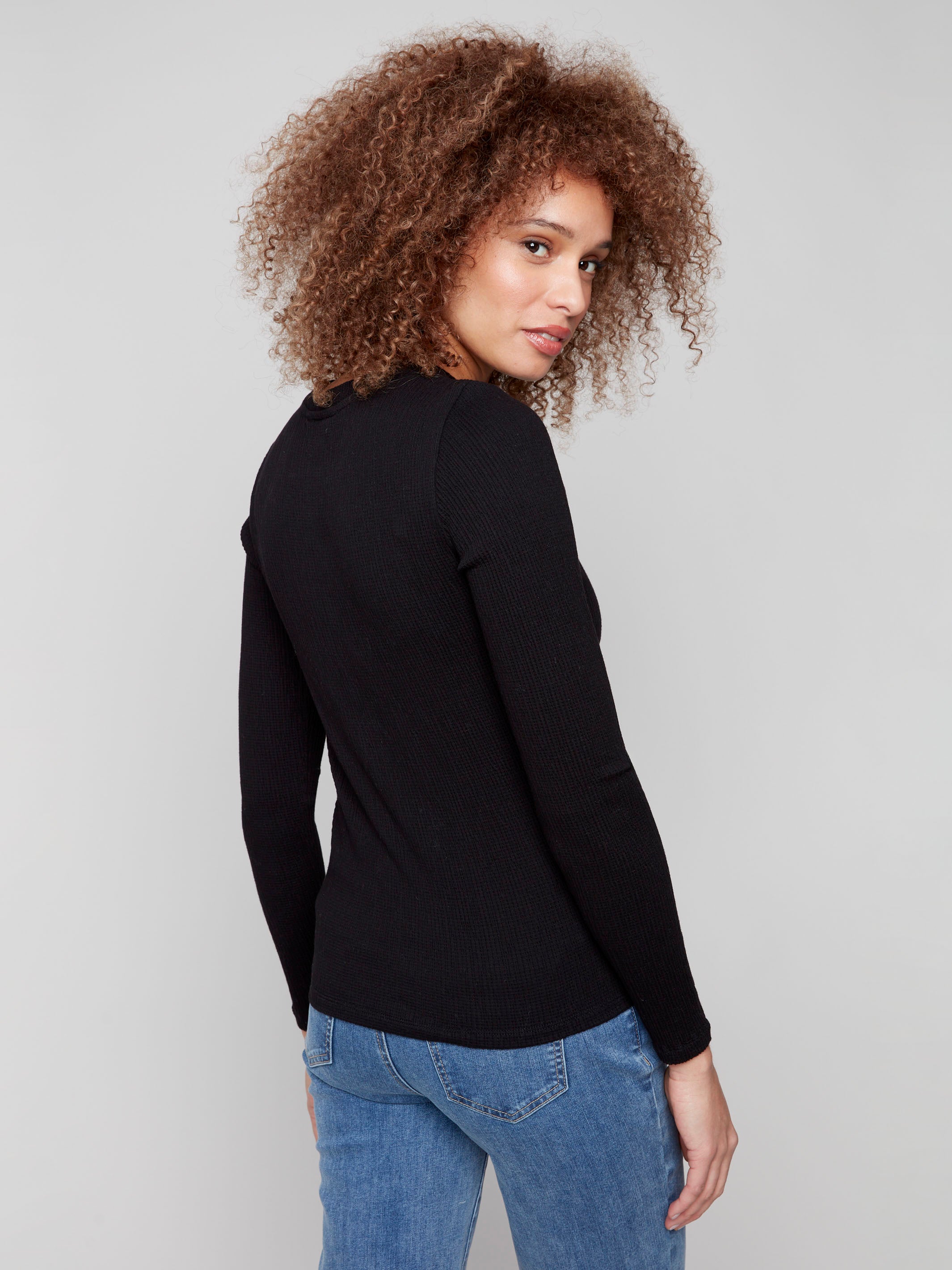 Black long sleeve textured knit top with a front knot by Charlie B.