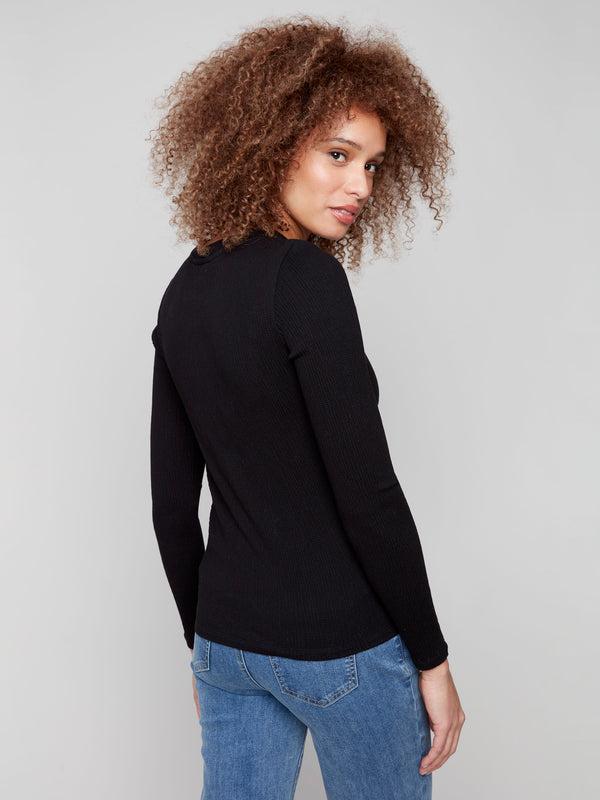 Black long sleeve textured knit top with a front knot by Charlie B.