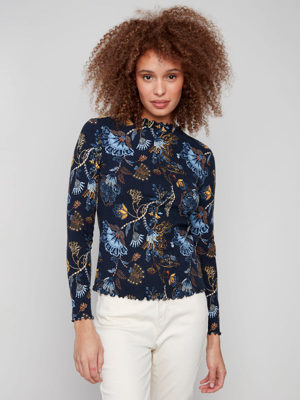 Floral top featuring a slim fit with elegant long sleeves and intricate detailing, perfect for any occasion by Charlie B.