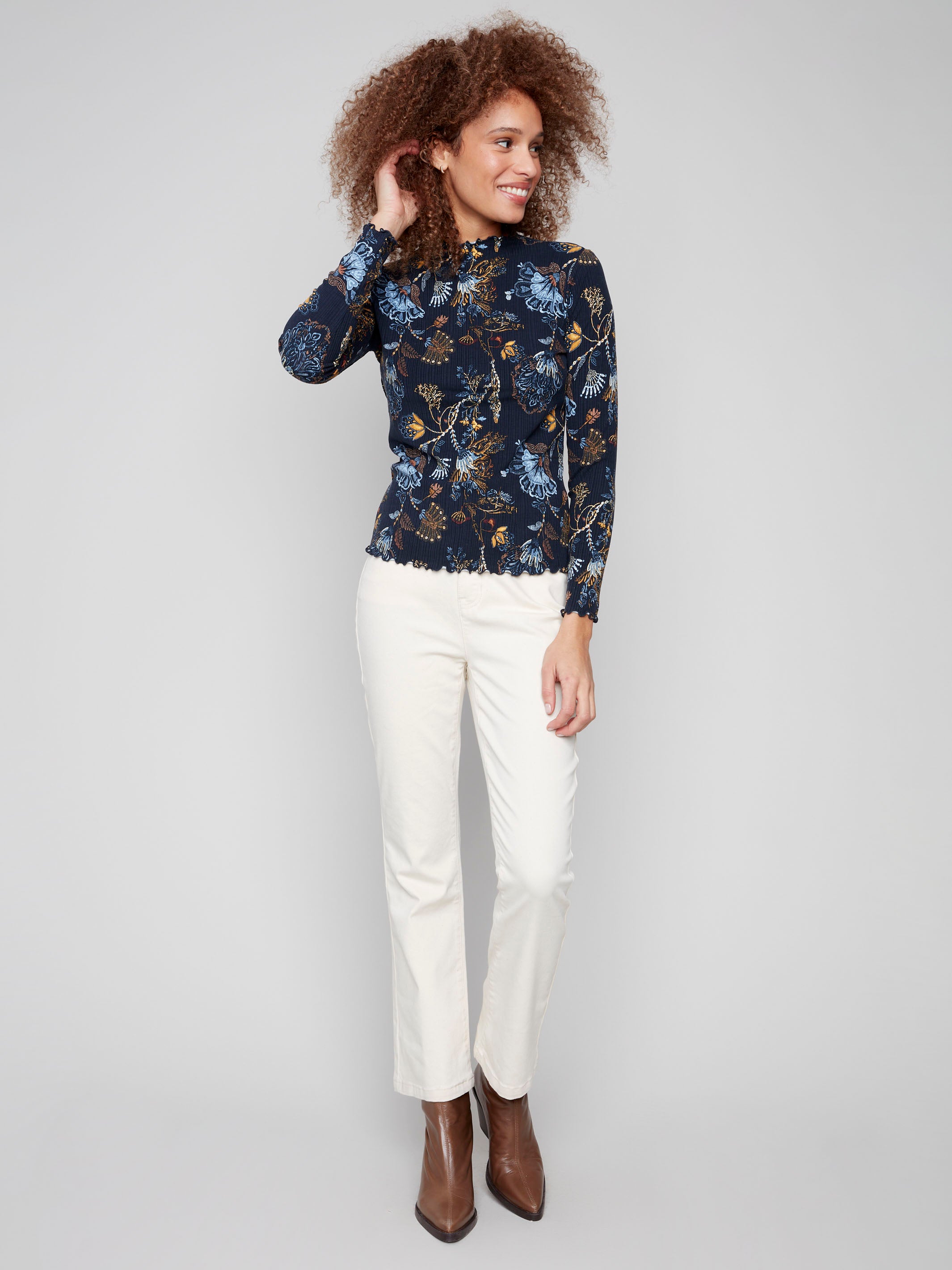 Chic mock neck top in a vibrant floral design, showcasing exquisite ruffle detail at the neckline and cuffs by Charlie B.
