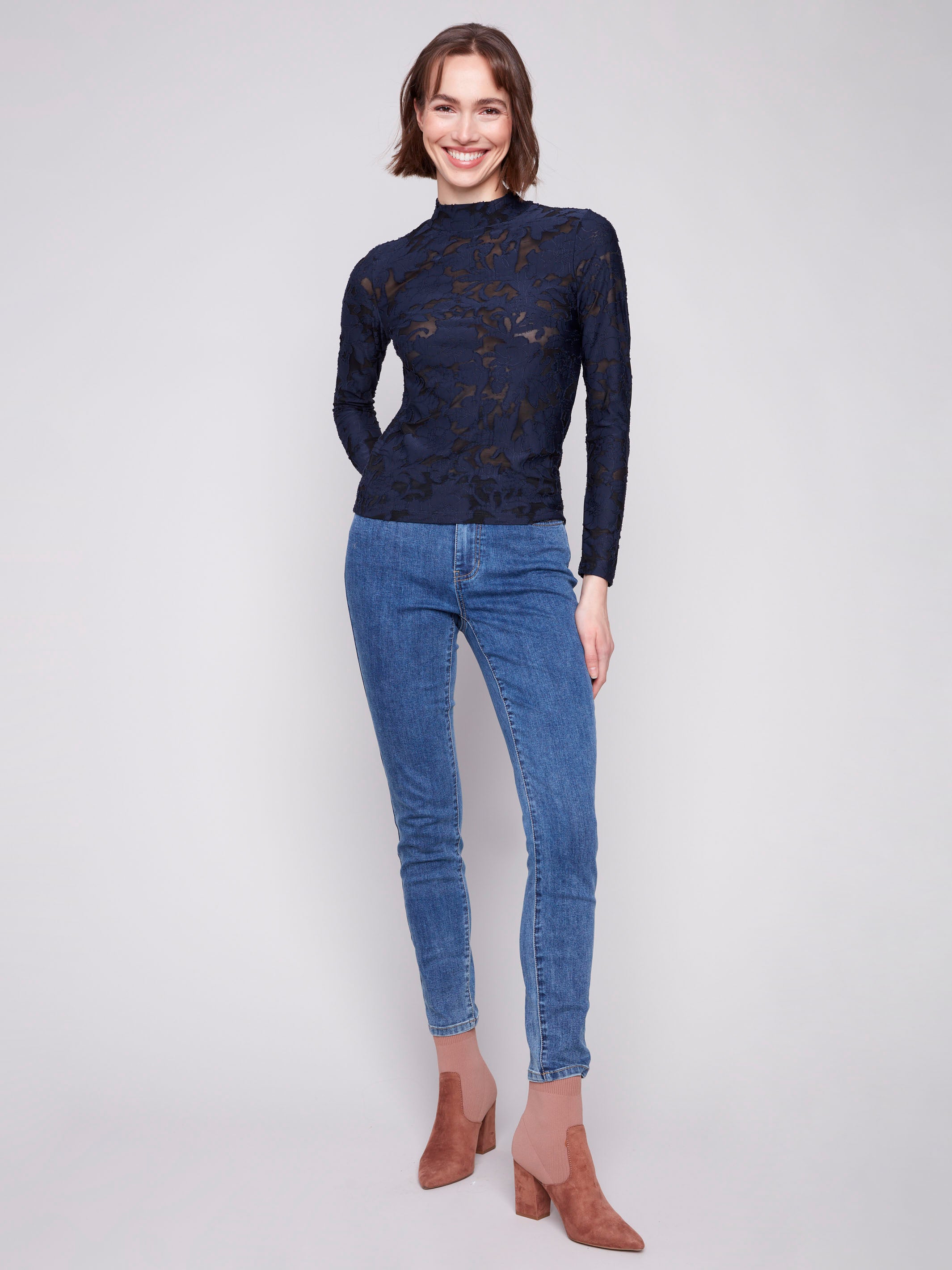 Mock neck blue black top with mesh fabric and intricate burnout pattern for a chic look by Charlie B.