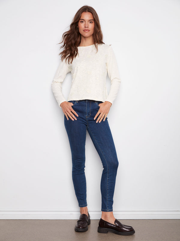 This long-sleeve ecru top features a classic crew neckline and is made from soft cotton by Charlie B.