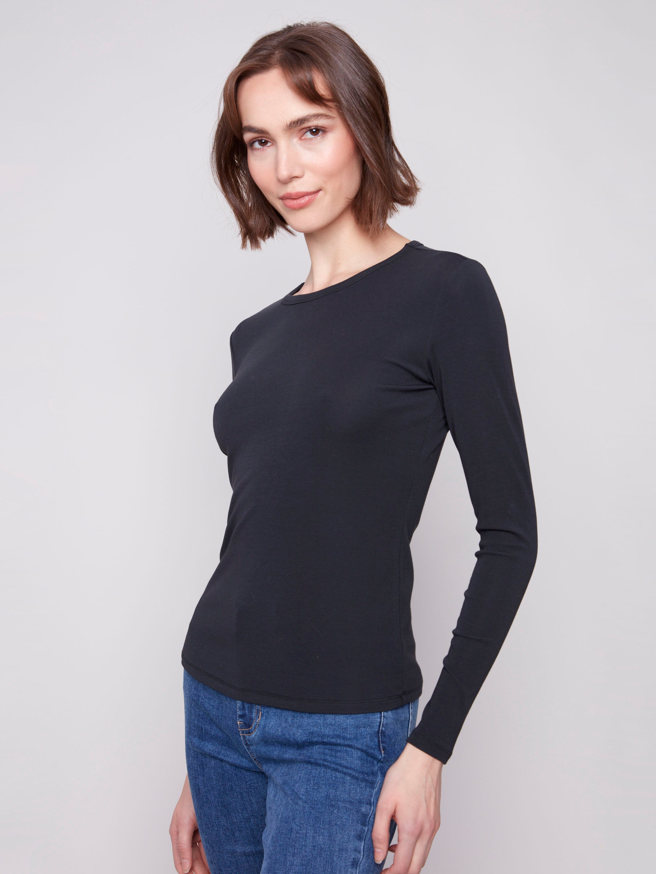 Chic long sleeve black top featuring a slim fit design, ideal for layering or wearing alone by Charlie B.