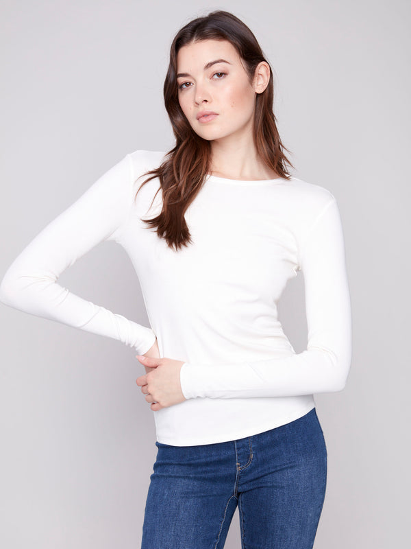 Sophisticated slim fit ecru knit top with a classic design by Charlie B.