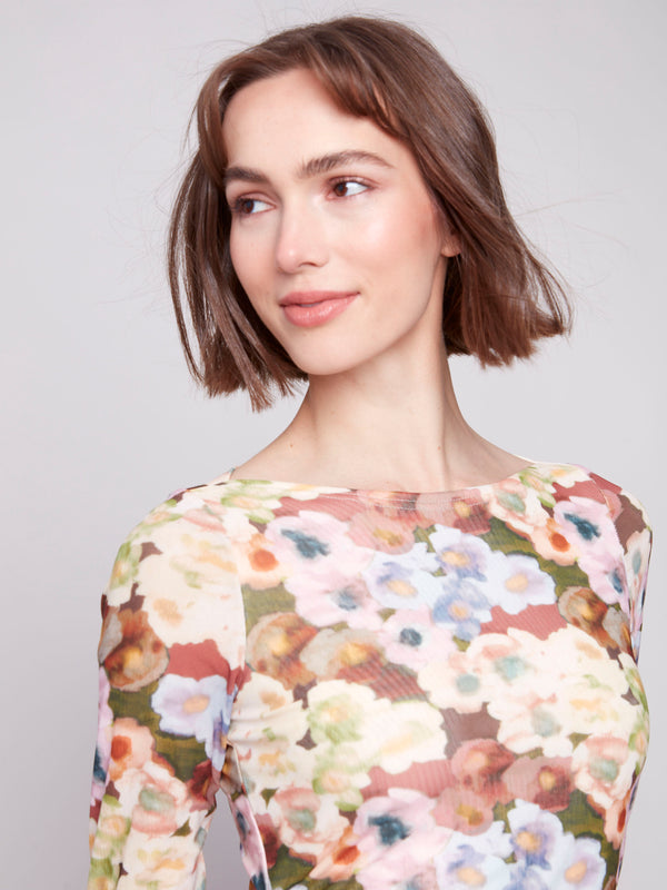 Vibrant floral design on this lined front and back mesh top adds a touch of elegance by Charlie B.
