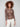 Leopard printed mesh top with ruching at the sides, long sleeves, and a boat neckline by Charlie B.