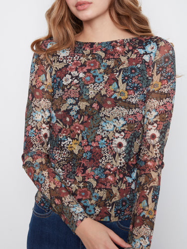 Long sleeves enhance the floral top's charm, offering both style and comfort. Ideal for cooler days without compromising on fashion by Charlie B.