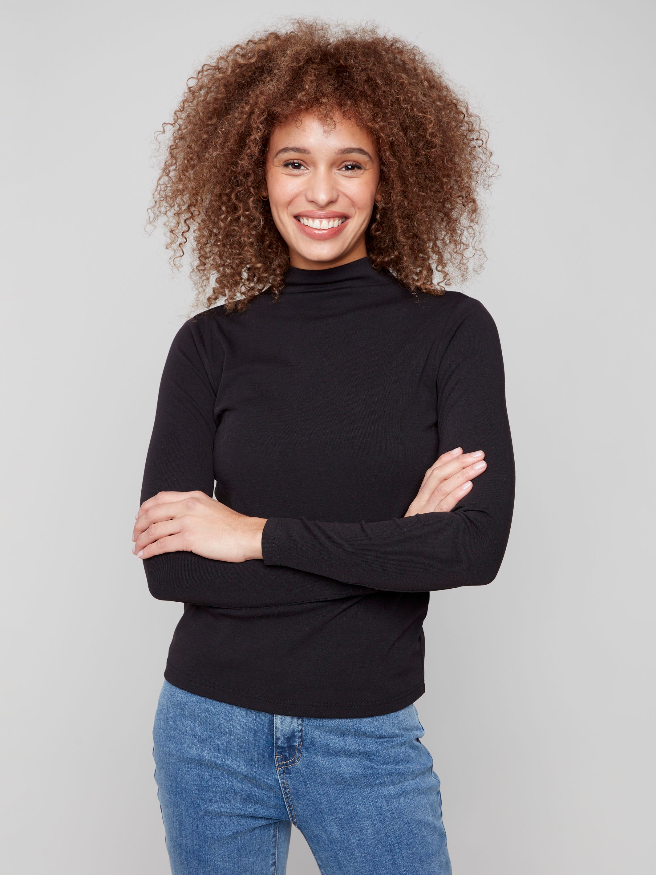 Black mock neck top featuring a slim fit and long sleeves, perfect for a sleek silhouette by Charlie B.