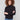 Black mock neck top featuring a slim fit and long sleeves, perfect for a sleek silhouette by Charlie B.