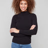 Black mock neck top featuring a slim fit and long sleeves, perfect for a sleek silhouette by Charlie B.