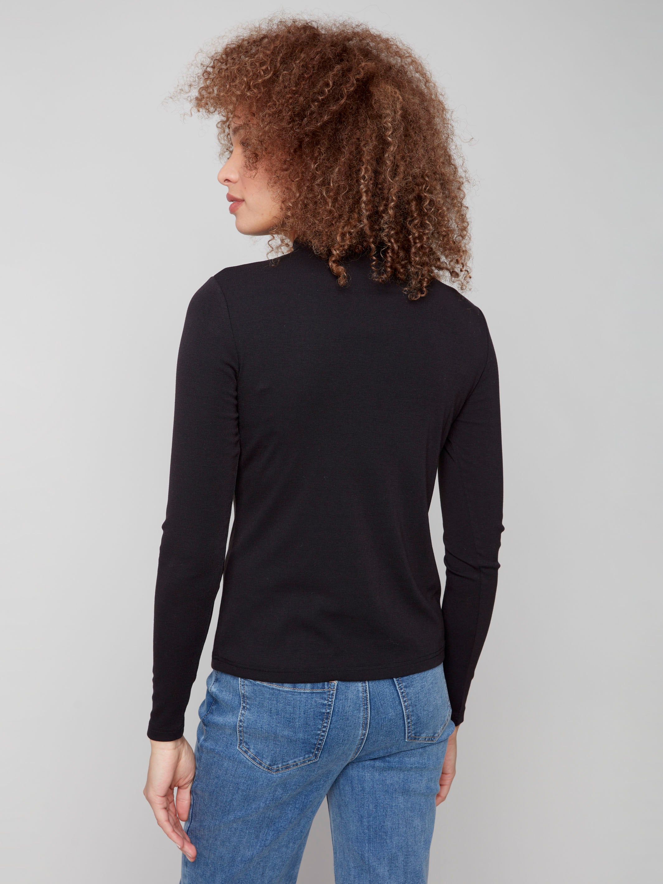 Chic black mock neck top highlighting its fine ribbed texture for added style by Charlie B.
