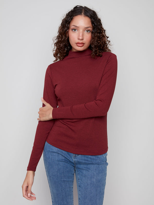 Elegant cabernet top featuring long sleeves and a sleek design by Charlie B.