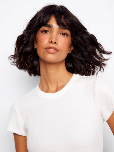 Showcasing short sleeves, this white tee delivers comfort and versatility for everyday wear by Charlie B.