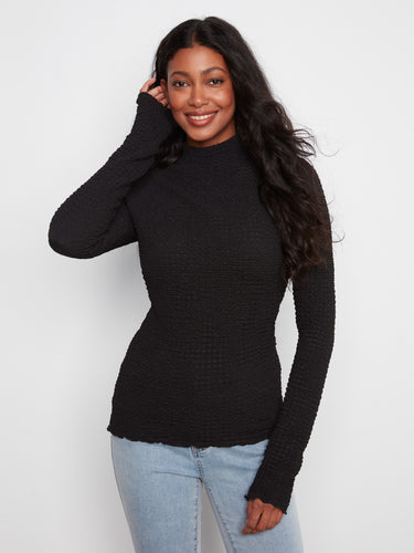 Black bubble knit top showcasing a slim fit with long sleeves and lettuce-edge trim by Charlie B.