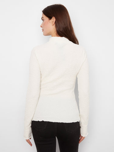 Mock neck detail elevates the look of this versatile top. Pair it with your favorite jeans for an effortlessly stylish ensemble by Charlie B.
