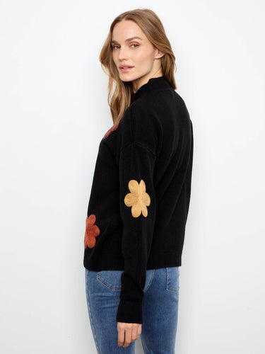 Contemporary style meets comfort in this flower-embellished, ribbed hemmed sweater by Charlie B.