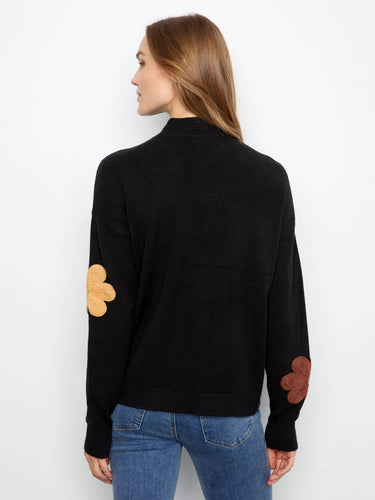 Experience comfort with the drop shoulder design paired with intricate floral details on this sweater by Charlie B.