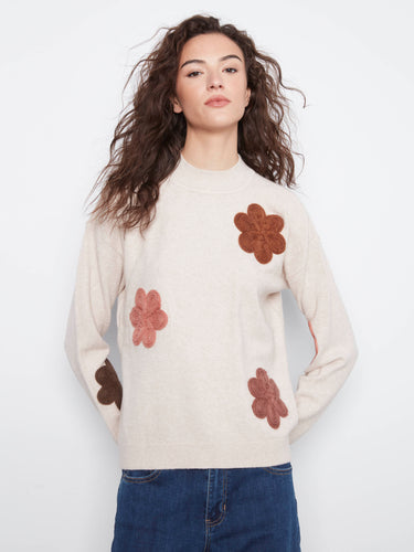 Sweater featuring a crew neckline with floral appliqué embroidery, offering a stylish touch to any casual outfit. By Charlie B.