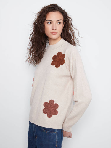 Casual yet stylish sweater featuring ribbed cuffs and hem, complemented by beautiful floral appliqué details. By Charlie B.
