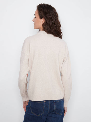 Sweater designed with drop shoulders and intricate floral appliqués, creating a modern aesthetic for everyday wear. By Charlie B.