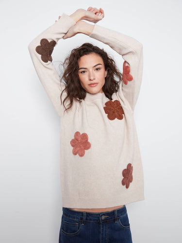 Cozy sweater boasting a classic crew neckline paired with lovely floral appliqué details for timeless style appeal. By Charlie B.